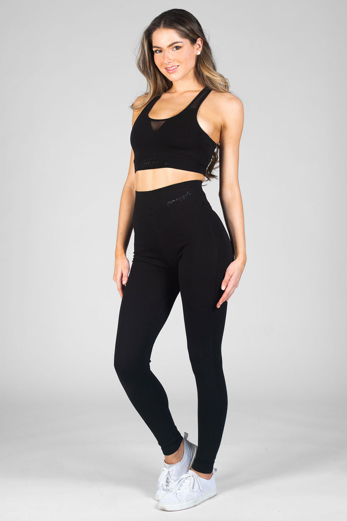 Woman wearing black High Waist Leggings and black Mesh Bra Top