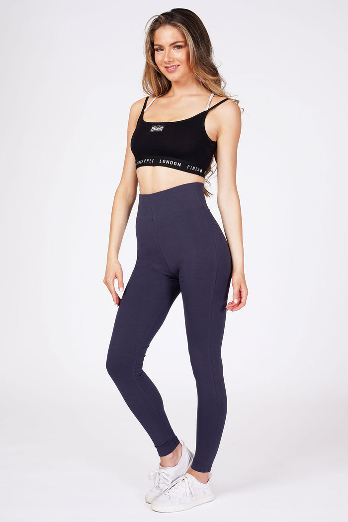 Woman wearingNavy High Waist Leggings and black bra top with logo hem