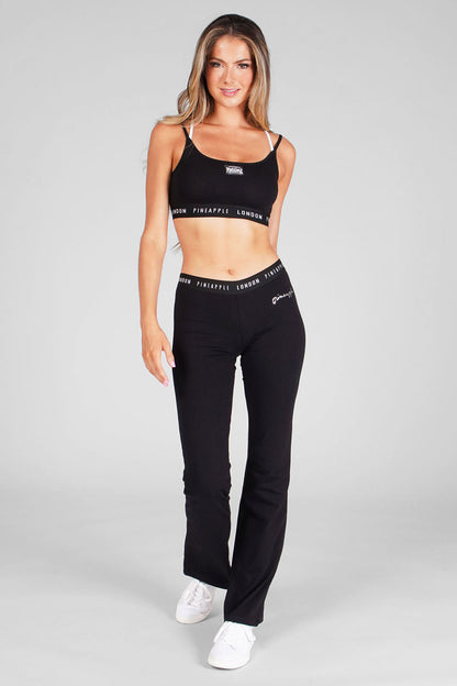 Woman wearing Black Jacquard Band Jersey Trousers and matching Black Strappy Bra Top