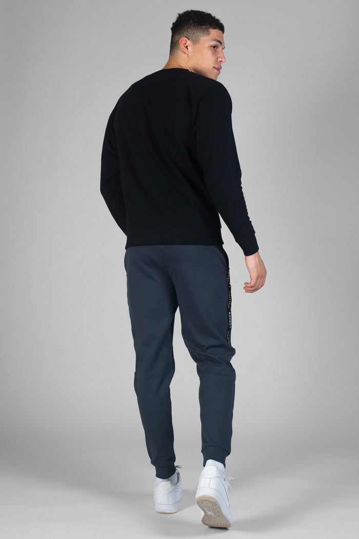 Man wearing charcoal Jacquard Joggers with pockets and black sweatshirt