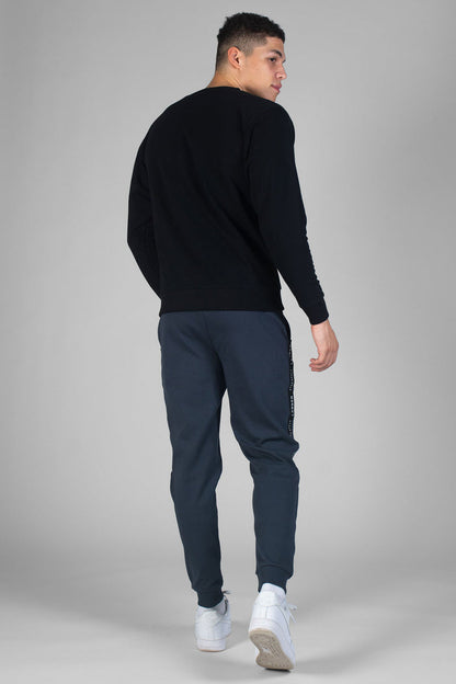 Man wearing charcoal Jacquard Joggers with pockets and black sweatshirt