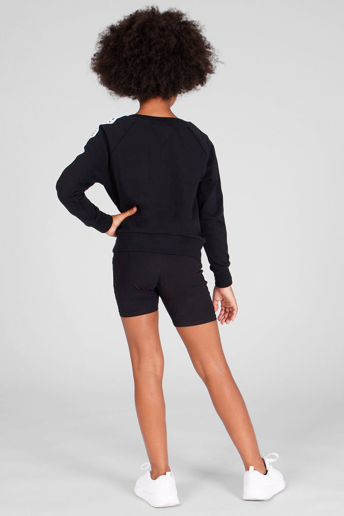 Girl wearing Jacquard Sweat Topwith long sleeves and black cycling shorts