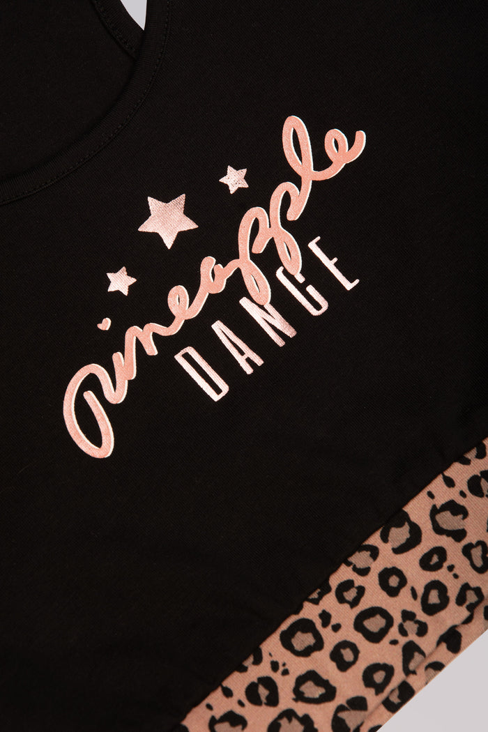 Pineapple Dance Studios branding on black dance crop top for kids