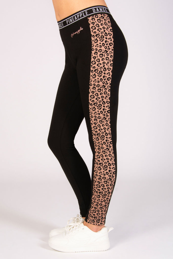Kids' black dance leggings with brown leopard panelling and small foil Pineapple Dance Studios logo on the hip