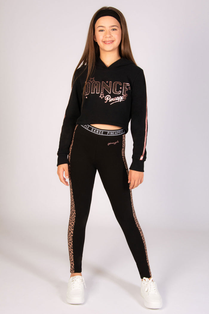 Black dance leggings for kids featuring a trendy brown leopard print panel along the legs.