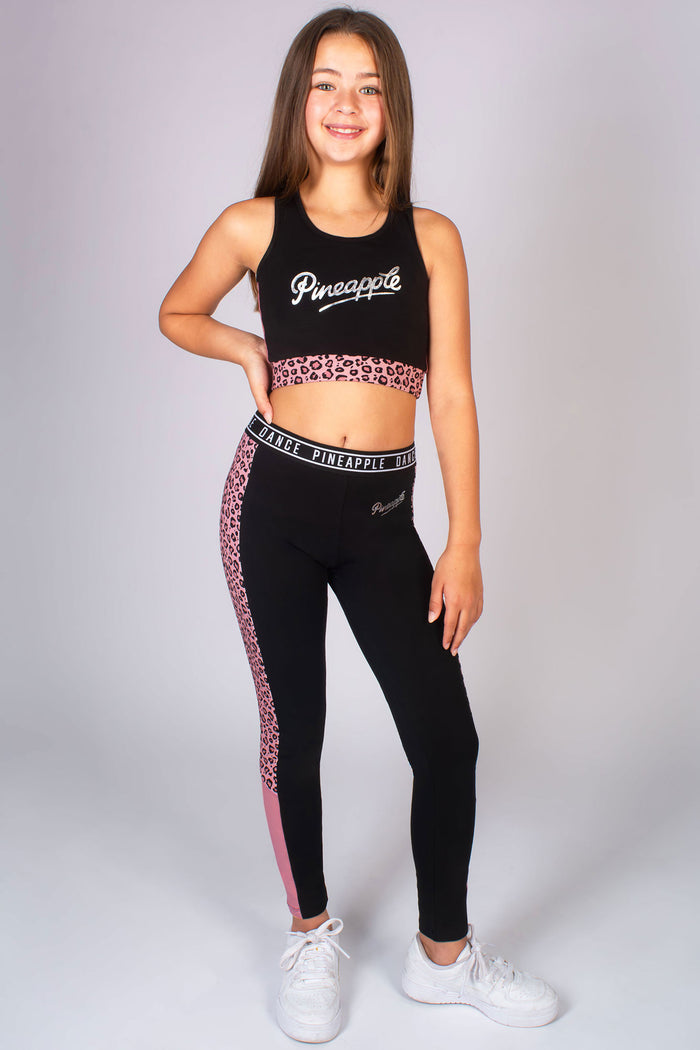 young dancers wearing coordinated black outfit featuring a black midi crop top and black leggings by Pineapple