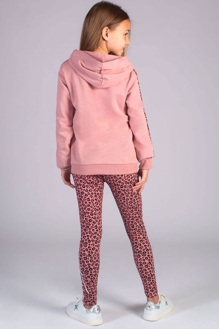 Young dancer wearing dusty pink hoodie from Pineapple with matching pink leopard print leggings for kids
