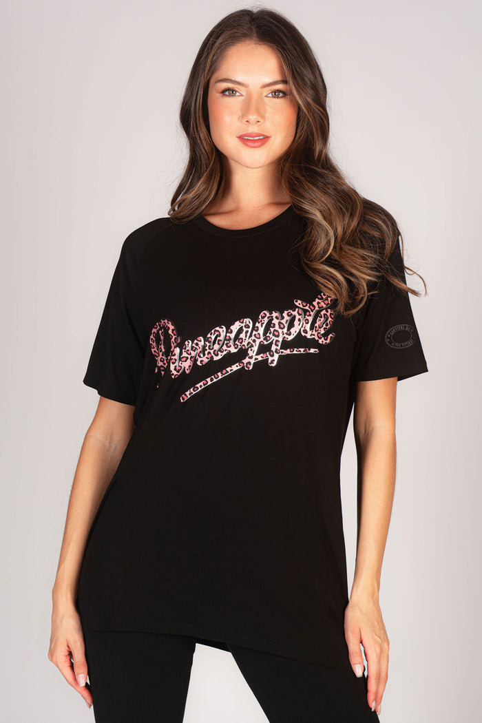 Kianna Louise wearing black boyfriend t-shirt featuring a Pineapple chest logo in pink leopard print