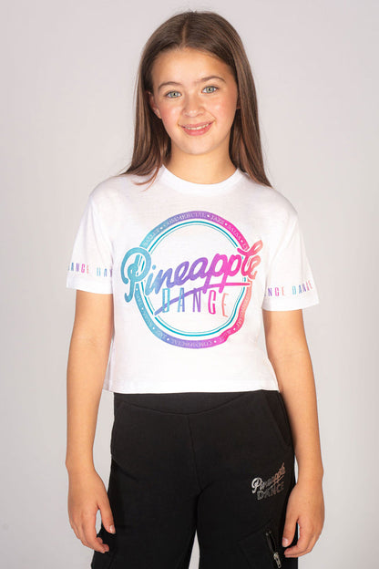 Girls' white crop t-shirt with rainbow Pineapple chest print and dance print across the sleeves.