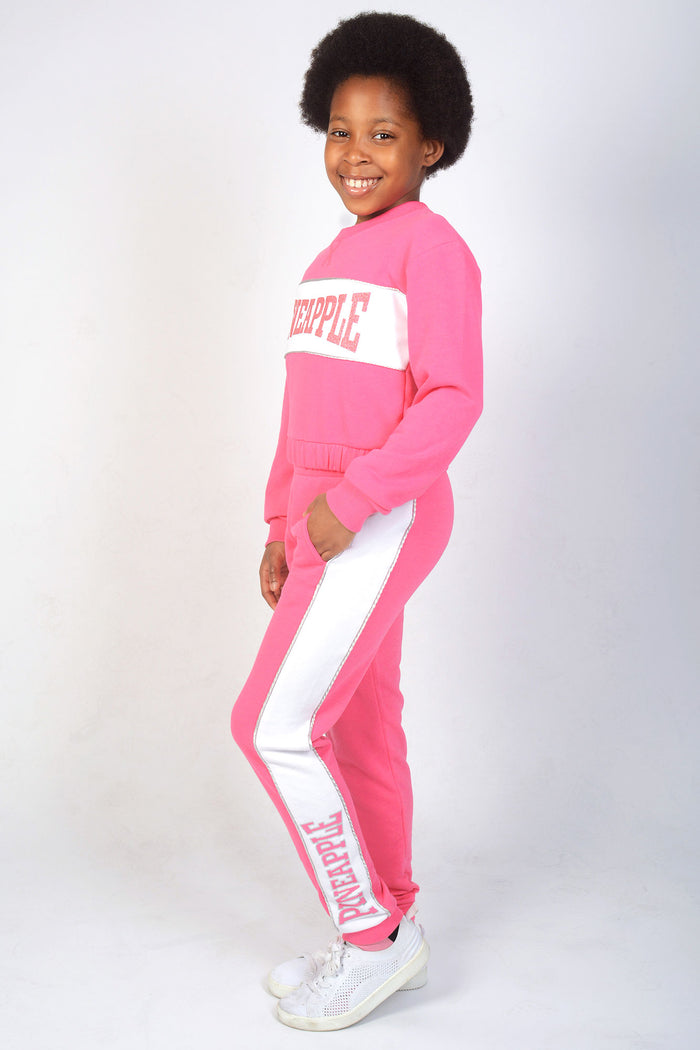 Girl wearing Pink Panel Joggers with pink logo on the legs