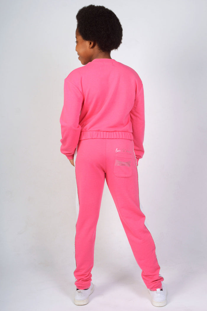Girl wearing Pink Joggers with logo back pocket and matching sweatshirt