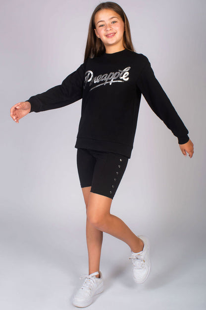 Black long sleeve jumper for girls with silver chest foil print paired with heart stud cycling shorts