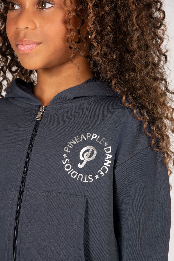 Dark grey hoodie with 'Pineapple Dance Studios' logo and zip fastening worn by a child