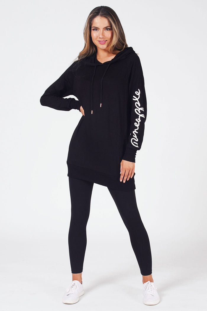 Woman wearing Black Longline Hoodie with drawstring neck and logo on left sleeve