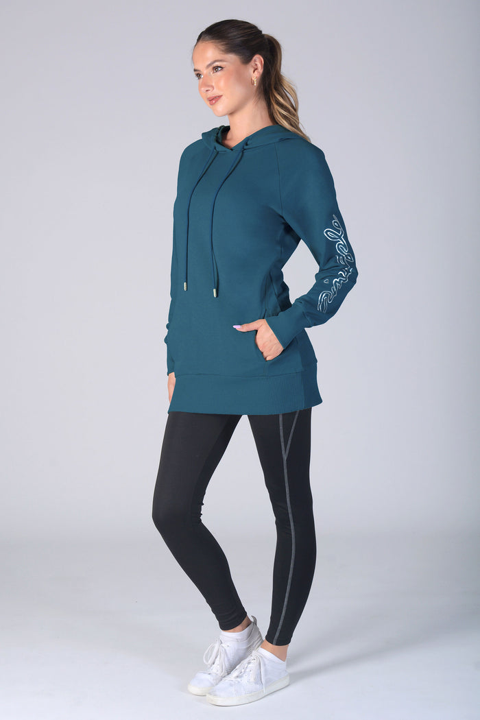 Woman wearing a blue hoodie and black leggings on a white background
