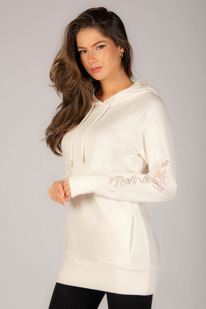 A best-selling hoodie in cream colour, featuring two side pockets, small gold foil print along the sleeve, perfect for any dance class!