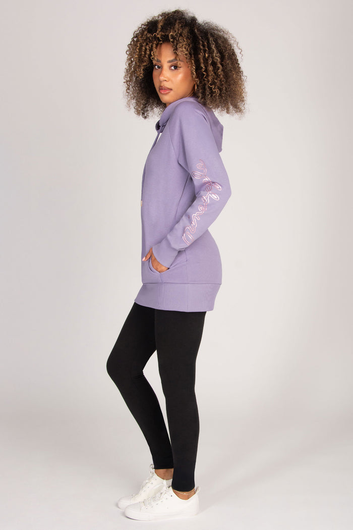 Woman wearing a light purple hoodie with pockets on a white background