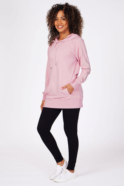 Woman wearing Pink Loopback Longline Hoodie with pockets and black leggings
