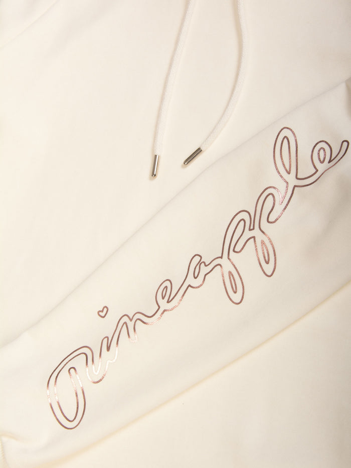 Detail shot of the sleeve and drawcords on this cream longline hoodie by Pineapple Dance Fashion.