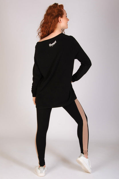 Black longline off-shoulder sweater for women paired with panel dance leggings.