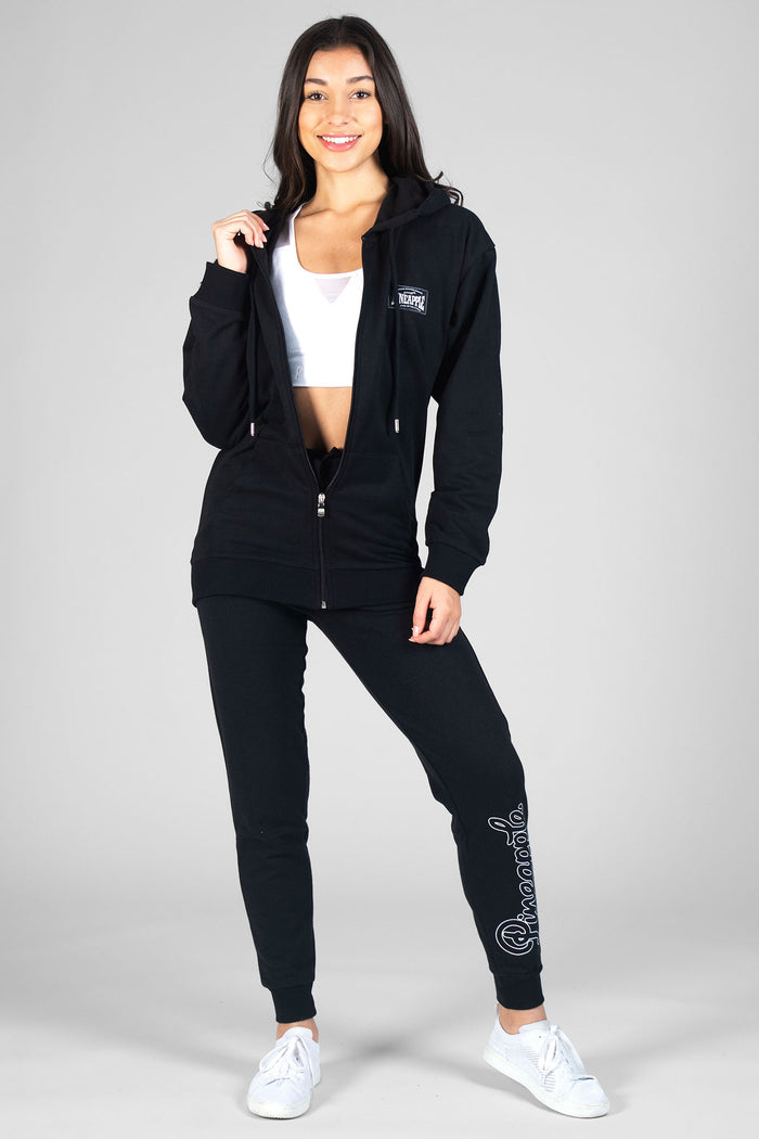 Woman wearing black Loopback Joggers, white Mesh Bra Top and black hooded jacket