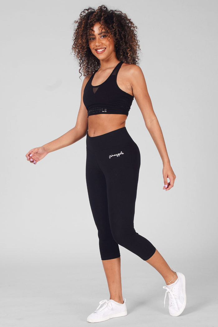 Woman wearing Black Mesh Bra Top and cropped wide band black leggings