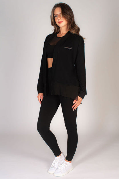 Women's black mesh cardigan worn with black basic leggings