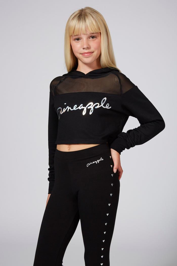 Girl wearing Black Mesh Panel Crop Hoodie and black leggings