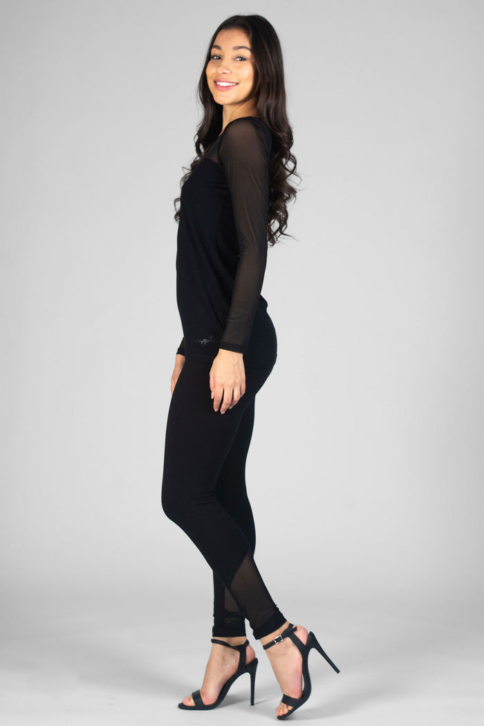 Woman wearing black Monroe Leggings and black Mesh sleeve Panel Top