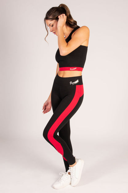 Women's lack crop top with red paneling and small Pineapple Dance Studios logo.