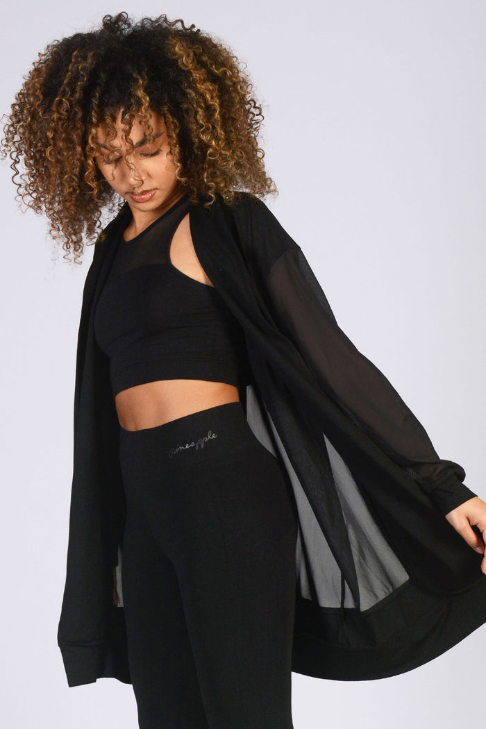 Monochrome sport luxe outfit with mesh cardigan and pockets