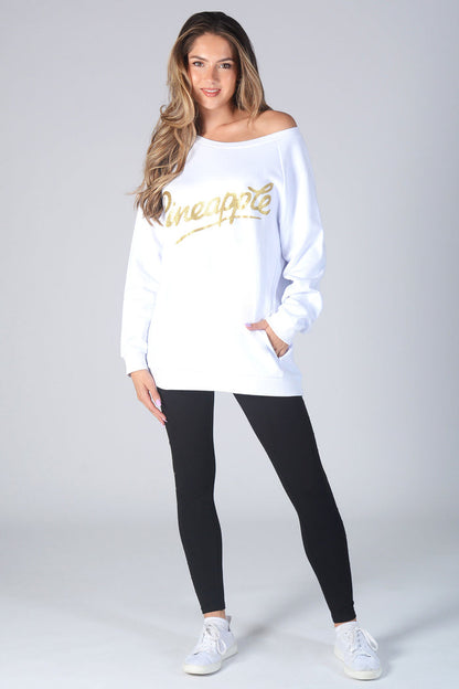 Woman wearing white Monster Sweater with gold Glitter logo and black leggings