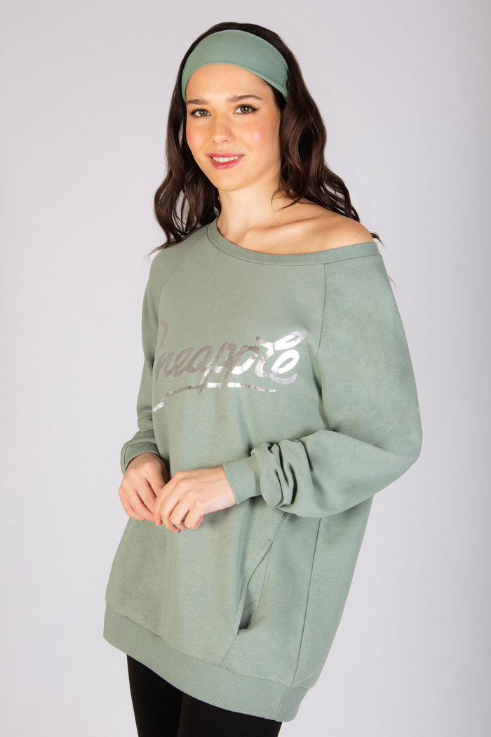 Light green off shoulder sweater for women with silver foil Pineapple logo across the chest