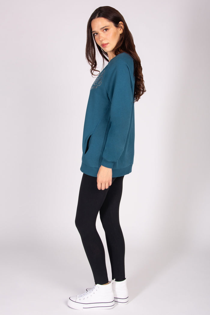 Woman wearing teal oversized longline sweatshirt
