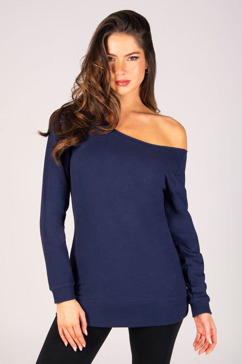 Kianna Louise wearing off shoulder dark navy sweat top with rib cuffs and raw edge neckline.