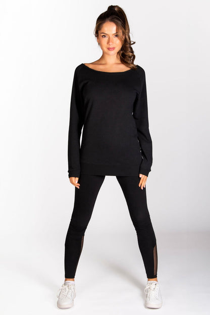 Kianna Louise wearing Pineapple off-shoulder longline sweat top in black