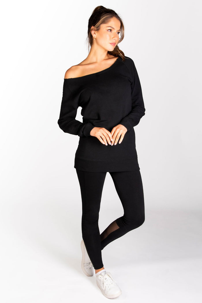 Off-shoulder long sleeve top in black paired with mesh panel leggings in black.