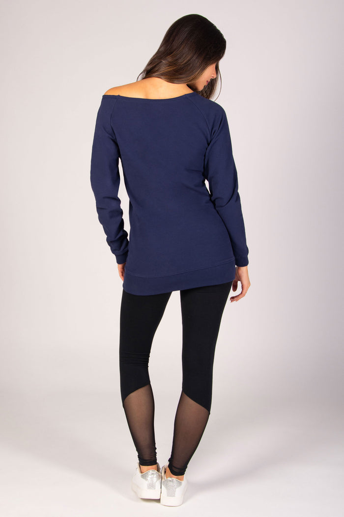 Women's dark navy longline sweater with off-shoulder neckline paired with mesh panel leggings.