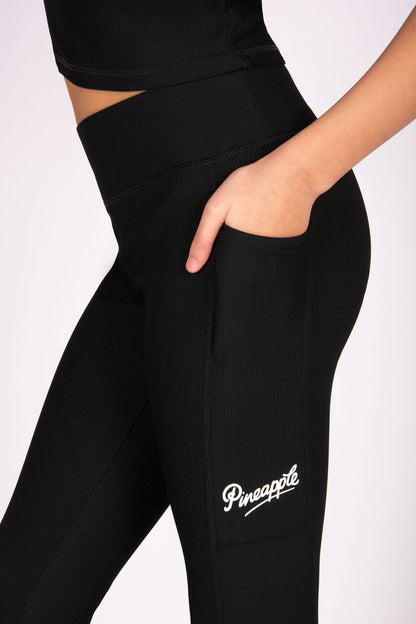 Girls' black rib leggings with hidden side pockets for small gadgets.