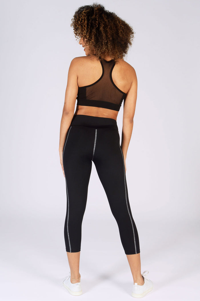 Womens' black workout outfit complete with performance leggings and mesh crop top from Pineapple