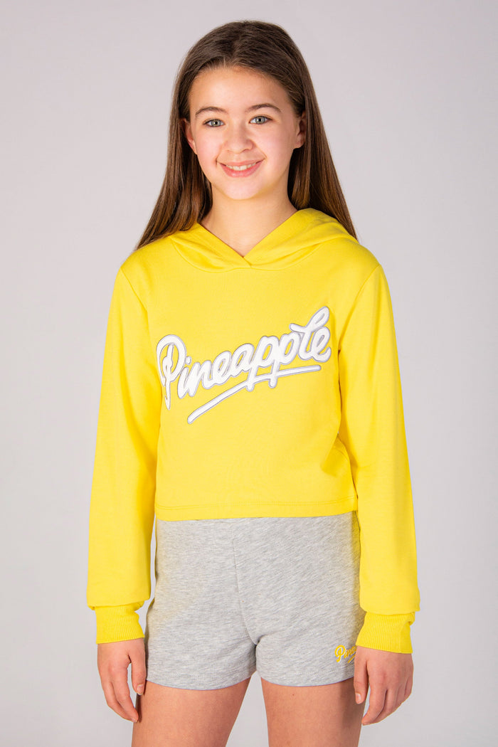Girls' yellow hoodie with Pineapple Dance Studios chest logo print.