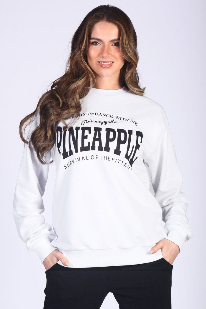 Kianna Louise wearing classic oversized crew neck jumper in white with black Pineapple Dance Studios logo across the chest