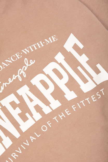 Detail shot of white chest print featuring Pineapple Survival Of The Fittest logo
