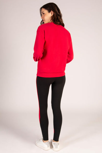 Red Christmas jumper for women paired with cotton rich black leggings.