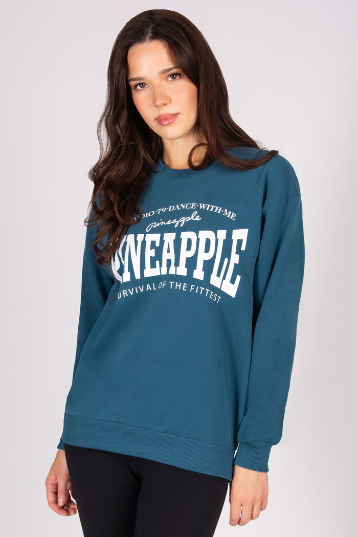 Woman wearing teal oversized sweatshirt