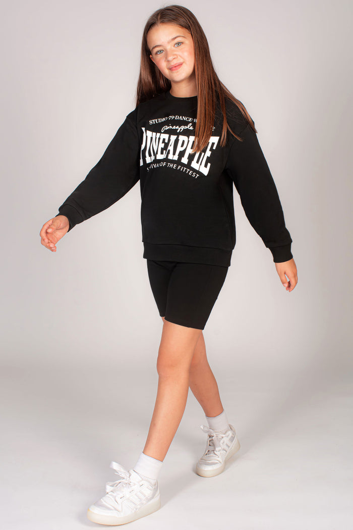 Girls' black sweater with white Pineapple logo chest print.