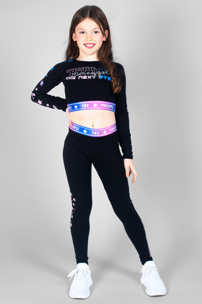 Girl wearing black TNS Long Sleeve Crop Top and matching leggings