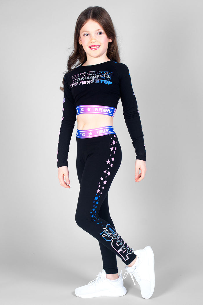 Girl wearing black TNS Long Sleeve Crop Top and TNS Ombre Star black leggings