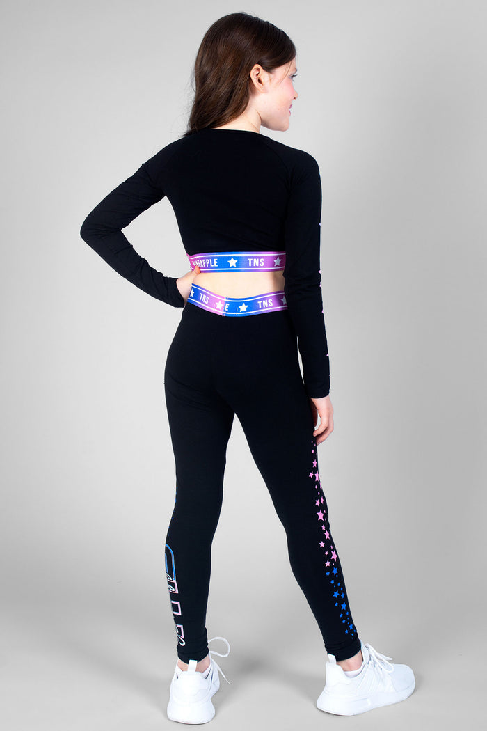 Girl wearing black TNS Long Sleeve Crop Top with ombre logo waistband and TNS Ombre Star black leggings
