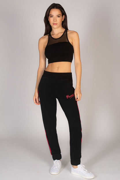 Martyna Balsam wearing sportswear by Pineapple Dance Studios featuring women's black joggers with red stripe.